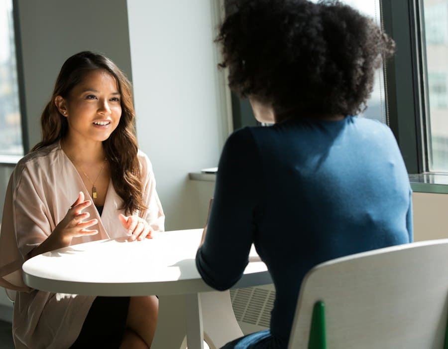 A candidate talking with a recruiter at a table