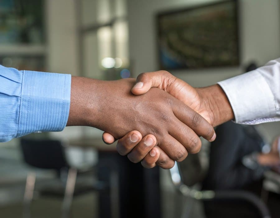 Two people shaking hands after an interview